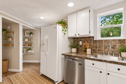 Kitchen with pantry and closet. Back door to the yard to the left of the fridge.
