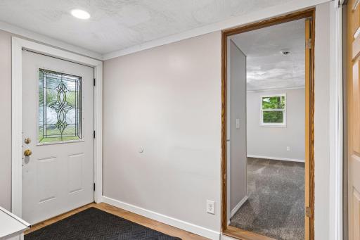 Generous sized foyer with large closet and built in bench