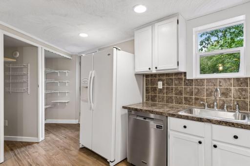 Kitchen with pantry and closet. Back door to the the yard to the left of the fridge.