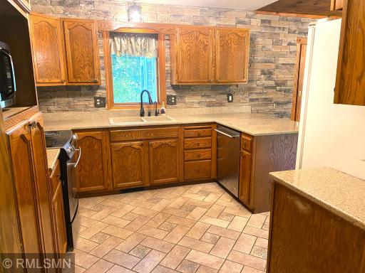 Kitchen Stone Paver Flooring ties in with the Foyer Flooring of the same