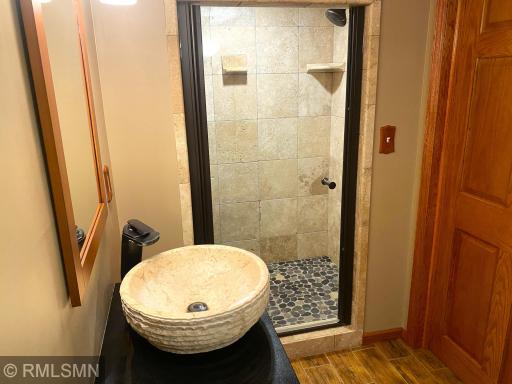 Lower-Level Bedroom Suite Stone Tile Shower Bat