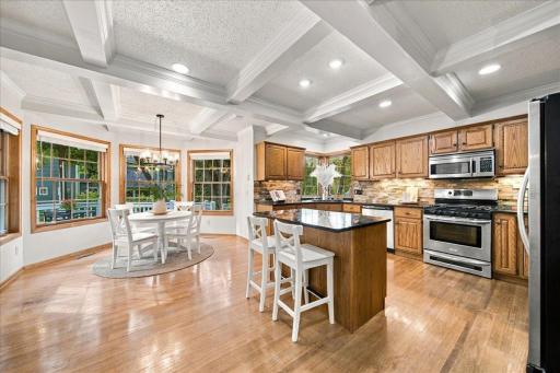 Coffered ceiling and recessed lights highlight the kitchen