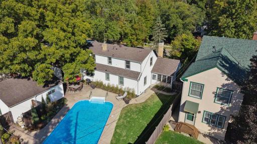 Backyard Aerial - Elevated view showcases the fenced backyard with in-ground swimming pool, expansive patio, lawn space, detached 2-car garage