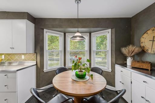 Kitchen Dining Area - A bay of three windows fills the casual dining area with natural light, creating an inviting spot for everyday meals just steps from the kitchen.