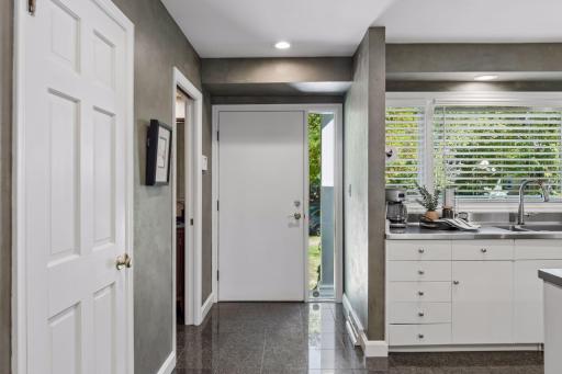 Entry & Kitchen - Front entry opens to tile flooring and a bright kitchen, offering a first look at the homeâs open, connected main-level layout.