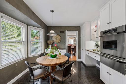 Kitchen Dining Area - Another angle shows the casual dining area, built-in cabinetry, abundant windows, and direct connection to the formal dining room.