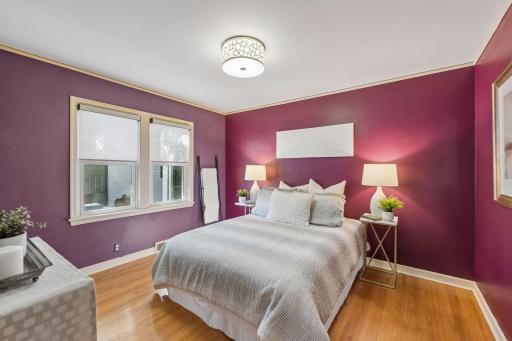 Main Floor Bedroom - Hardwood floors, two windows, and a distinctive wall color give this bedroom plenty of character, with room for a larger bed and accompanying furniture.
