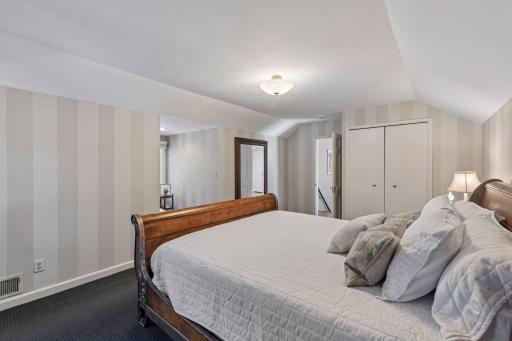 Upper-Level Bedroom - Reverse view highlights the generous dimensions, closet, and flexible layout of this upper-level bedroom.