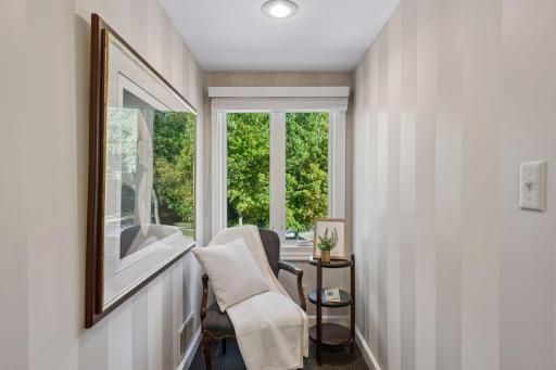 Reading Nook - A large window overlooking the front brings natural light into this cozy upper-level nook in the upper level bedroom.
