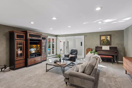 Family Room - Spacious main-level family room features abundant recessed lighting, large windows, comfortable gathering space, and direct access toward the detached garage, backyard, and pool.
