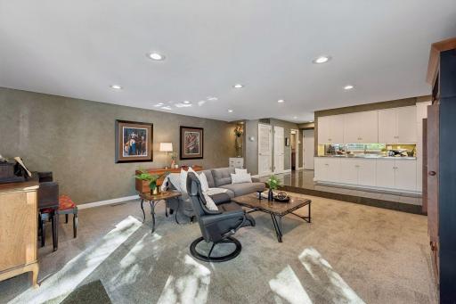 Family Room & Kitchen - Wide view illustrates the open connection between the expansive family room and kitchen, creating a spacious main-level gathering area with abundant recessed lighting.