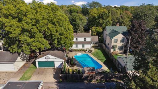 Backyard Aerial - Elevated rear view showcases the in-ground swimming pool, surrounding patio, fenced backyard, detached 2-car garage, and the homeâs rear elevation.