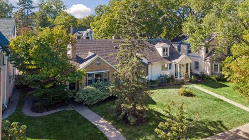 Front Aerial - Elevated view showcases the homeâs distinctive architecture, mature trees, established landscaping, and its setting among the classic homes of Southwest Minneapolis.
