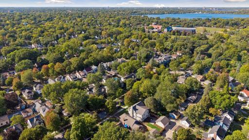 Neighborhood Aerial - Expansive aerial view highlights the homeâs Southwest Minneapolis location with nearby Lake Harriet visible beyond the surrounding tree-lined neighborhoods.