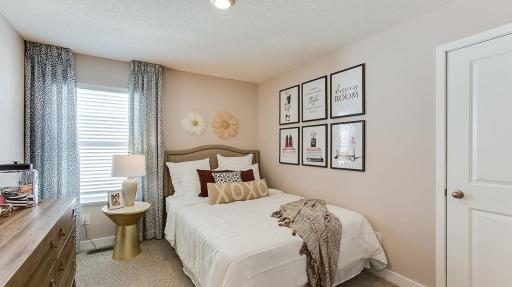Spacious bedroom #3 with lots of natural light. Photo is of model home. Colors and options may vary. Ask Sales Agent for details.