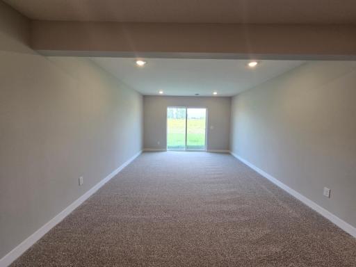 The Finnegan Walkout Lower Level Family Room at Highlands at Eagle View in Elko New Market. Photo is of actual home. Options and colors may vary. Ask Sales Agent for details.