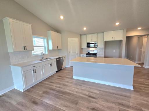 The Finnegan Kitchen shown with White cabinets at Highlands at Eagle View in Elko New Market. Photo is of actual home. Options and colors may vary. Ask Sales Agent for details.