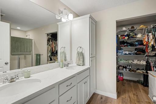 Double vanity primary bathroom with huge walk in closet