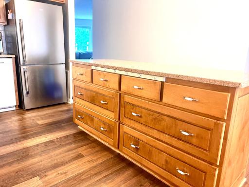Snack bar with power strip and stainless refrigerator.jpeg