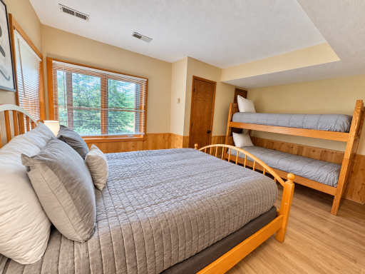 Lower level bedroom queen bed plus twin bunks.png