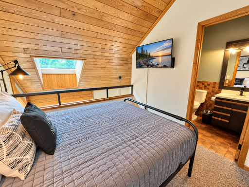 Lofted Master Bedroom with TV and Ensuite Bathroom.png