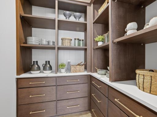 The walk-in pantry of your dreams with base cabinets, quartz tops and beautiful shiplap accents
