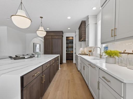 Ample storage space provided by the many cabinets and drawers throughout the kitchen