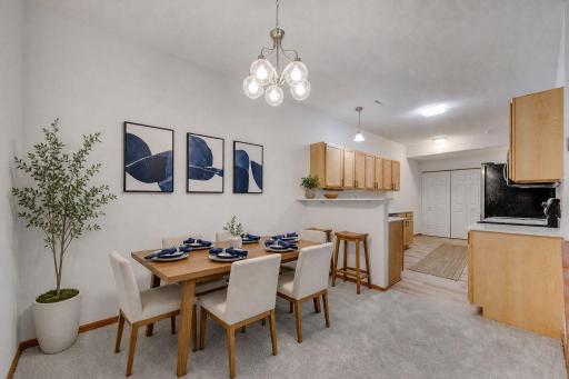Virtually Staged Photo of the dining room and kitchen area of the home.