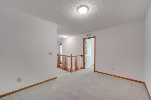 Upstairs, a peaceful loft space offers the flexibility to create your dream home office, reading nook, or cozy lounge.