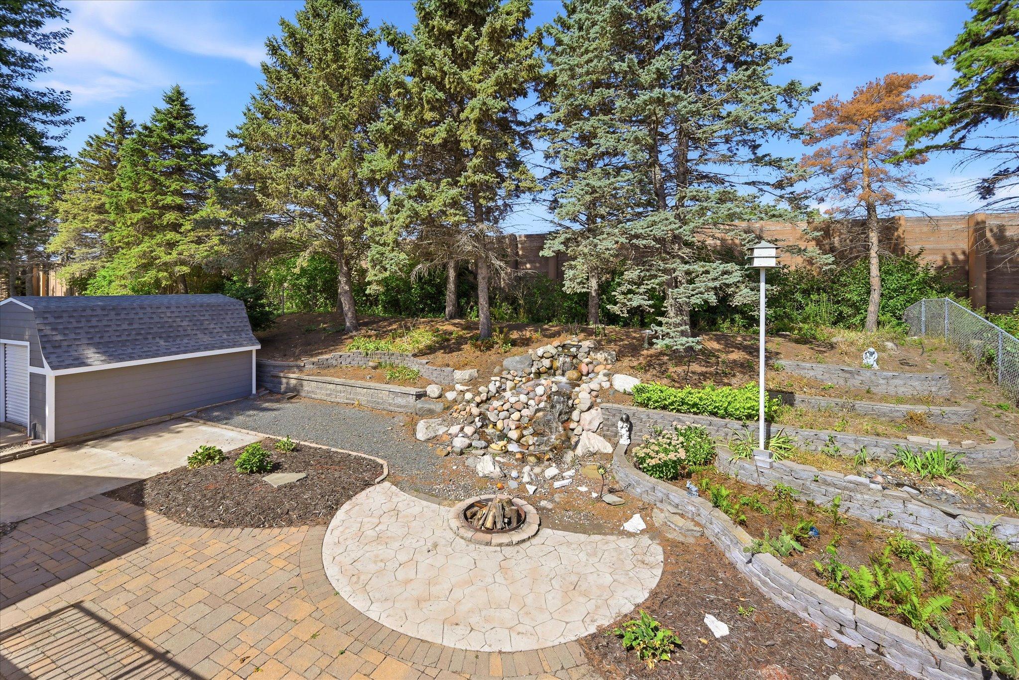 Hardscaped yard with Waterfall and Firepit