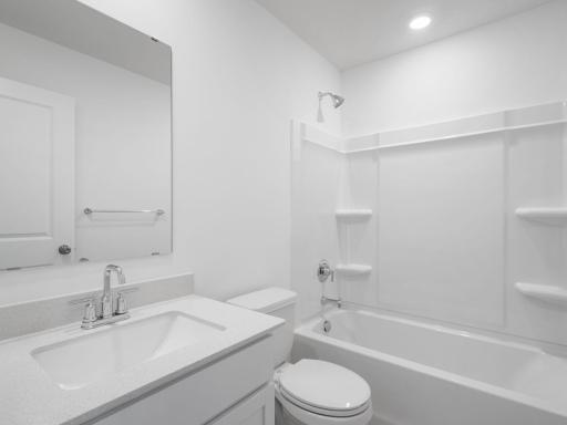 This full bathroom is located near the secondary bedrooms for convenient access, featuring a sink and shower-tub combination.