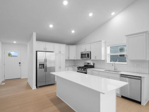 The stylish kitchen features an open layout with sleek cabinetry and an inviting center island, ready for creating chef-inspired recipes.
