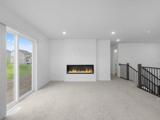 The inviting Great Room offers the space and comfort needed for seamless entertaining, with sliding glass doors offering convenient outdoor access.