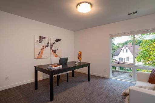 Dramatic windows bring tons of natural light into the fifth bedroom on the second level.