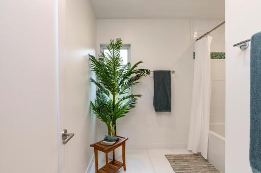 This bathroom features a A smart, share-friendly layout with a private water closet and separate room for the tub and shower..