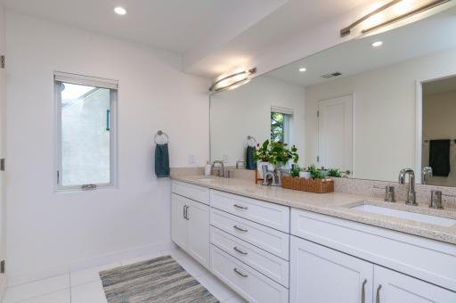 Spacious second full bathroom on the second level also features dual sinks.