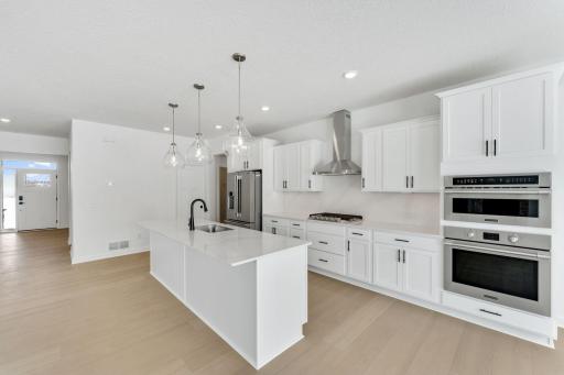 (Photo of a similar home, actual finishes may vary) Elevate culinary creations with cutting-edge stainless steel double wall ovens, designed for precision and performance