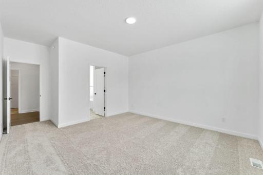(Photo of a similar home, actual finishes may vary) The owner’s suite is complete with a cozy bedroom, an ensuite bathroom and a walk-in closet.