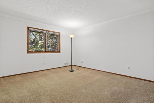 Generously sized bedroom with flexible space for a variety of needs overlooking the backyard.