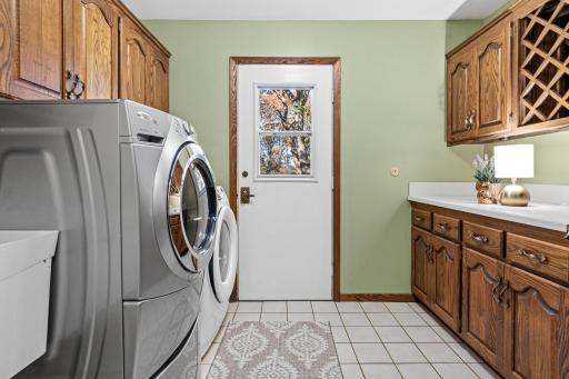 Main level laundry room with access to the large deck beyond. Great cabinet storage and counter space.