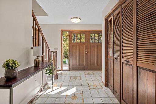 A warm and welcoming foyer with double entry doors and generous closet space provides a beautiful first impression and plenty of room to greet guests! Stairs lead upstairs to four spacious bedrooms.