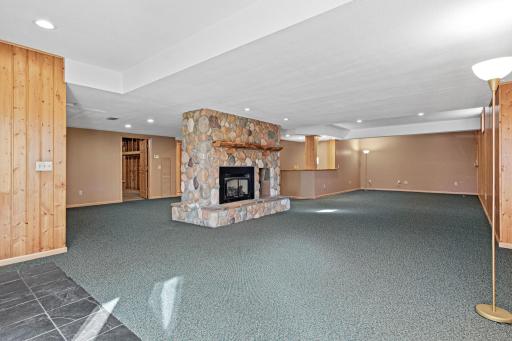 Gather around the beautiful stone fireplace for cozy evenings at home. Walk-out to your fenced backyard.
