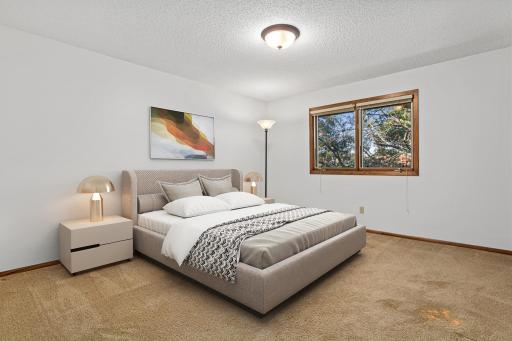 One of four bedrooms on the upper-level- it offers comfort, versatility and room to grow. Visually staged bedroom.