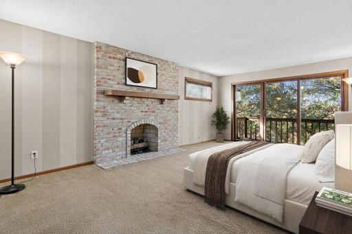 Incredible owner's suite- including a private balcony, wood burning fireplace and amazing nature views. Get a fire going and enjoy a wonderful night with the snow coming down! Visually staged photo.