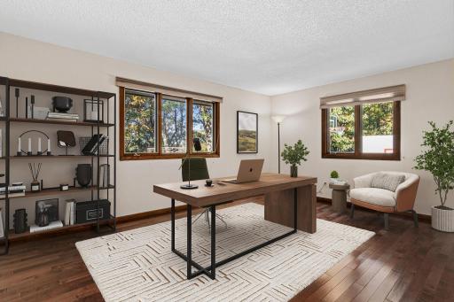 Main-level office offers a dedicated space for working from home, studying or creative projects. Could also be used as a main level bedroom by adding a closet. Visually staged office.