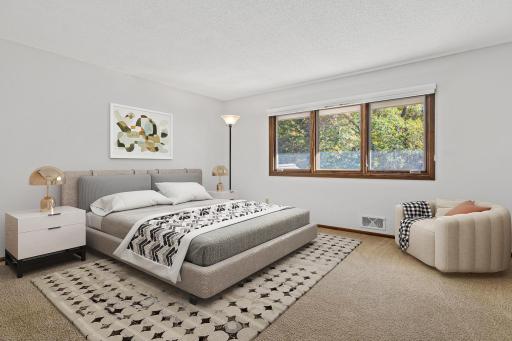 One of four bedrooms on the upper level. This one overlooks the front yard. Visually staged.
