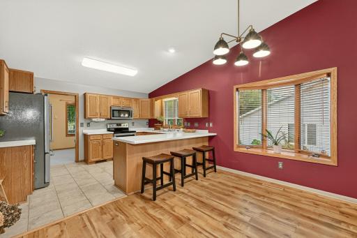 Large dining space with bay window and new light fixture.