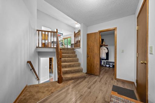 Large welcoming foyer, open staircase with LVP flooring and mudroom closet. Beautiful LVP flooring in foyer and closet.