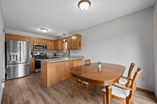 Spacious informal dining seamless open to kitchen and walkout to backyard deck.