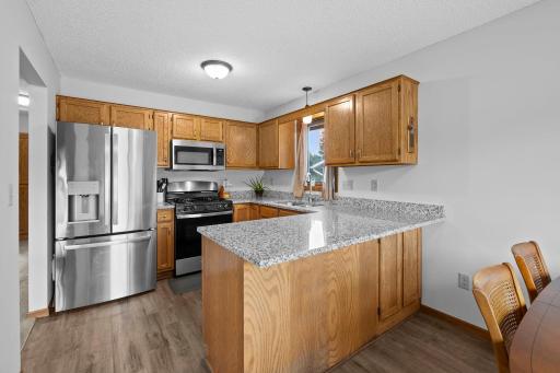 Beautifully updated kitchen with Granite countertops! Informal dining and breakfast bar for easy dining!